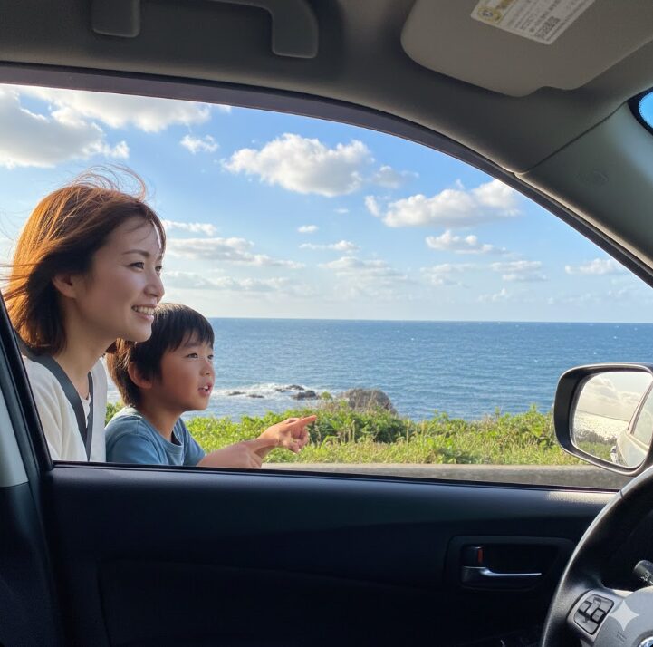 三浦半島をドライブする家族。海岸線を走る車の窓から、海と空の美しい景色を眺めている日本人女性と子供。